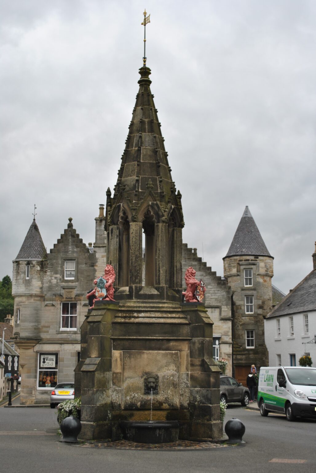 A stone market cross in a Fife burgh square