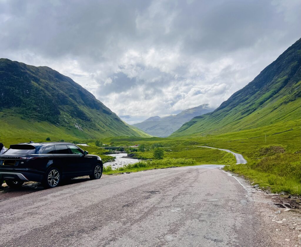Tycoon Tours' black Range Rover parked on the road through Glen Etive in the Scottish Highlands