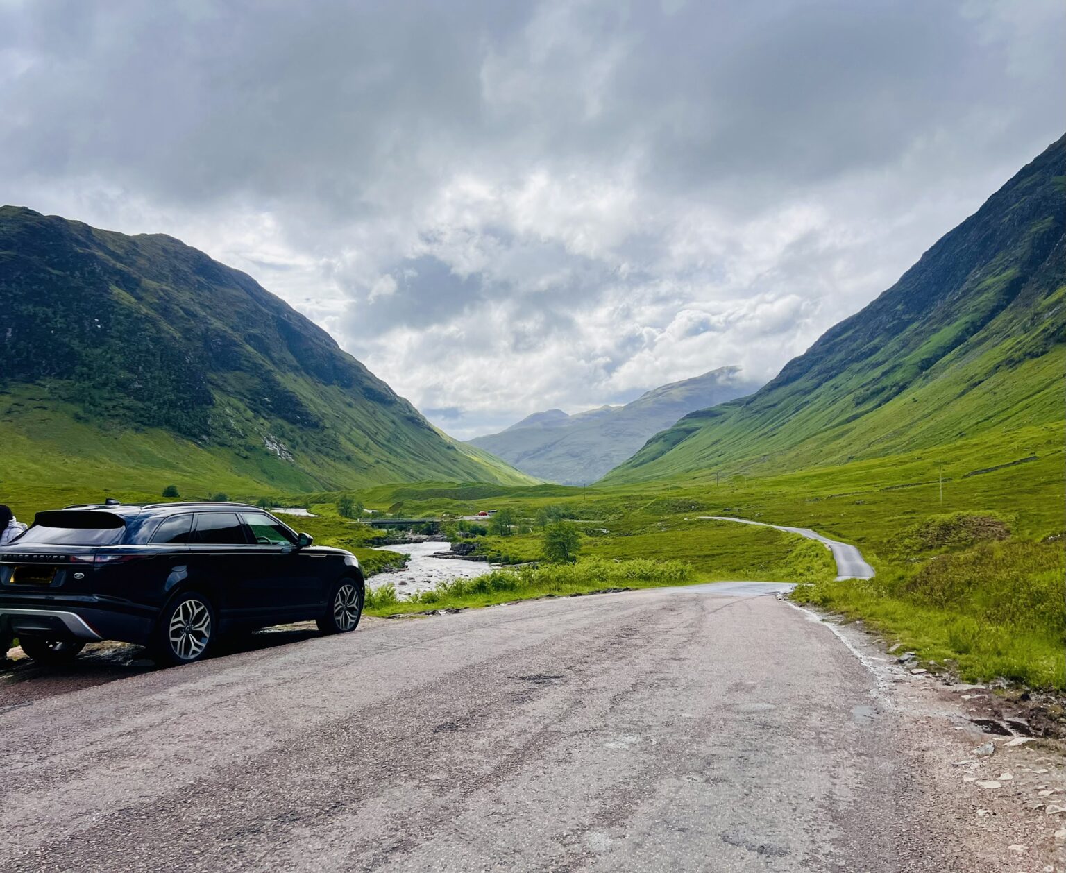 Tycoon Tours' black Range Rover parked on the road through Glen Etive in the Scottish Highlands