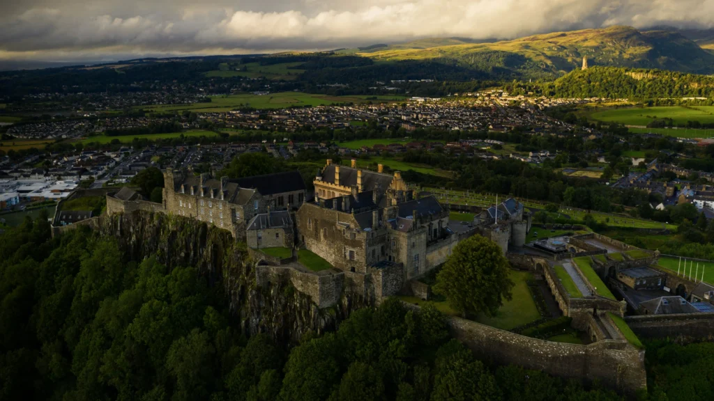 Aerial view of Stirling Castle on its crag above Stirling Old Town, with the Wallace Monument on the skyline