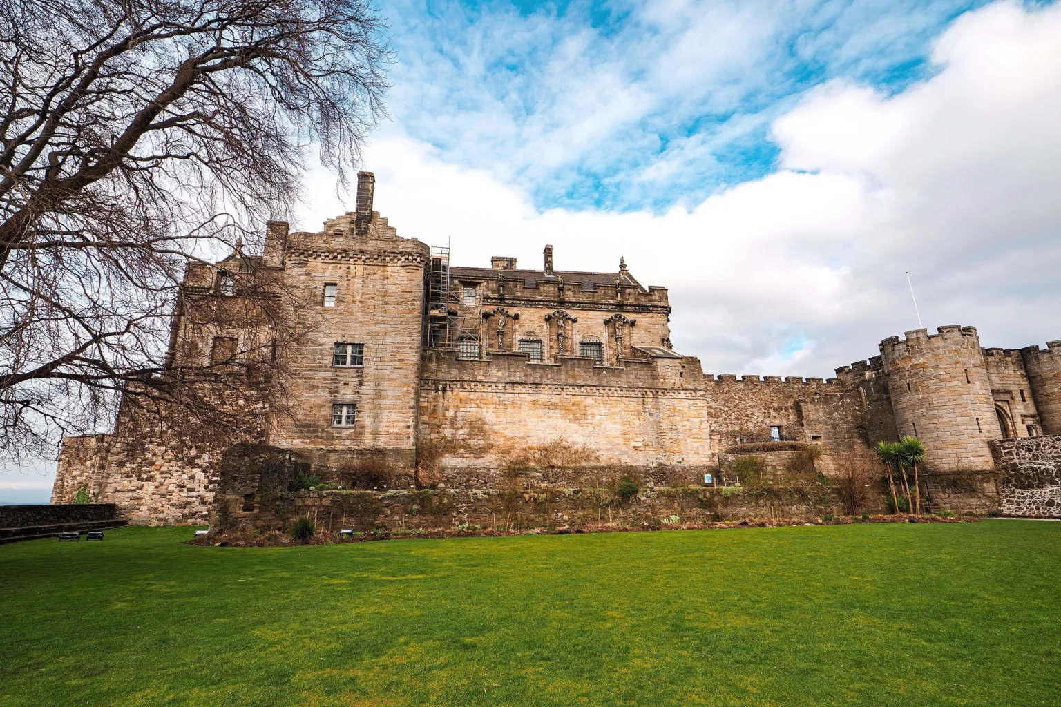 The royal palace and curtain walls of Stirling Castle above a green lawn, Scotland