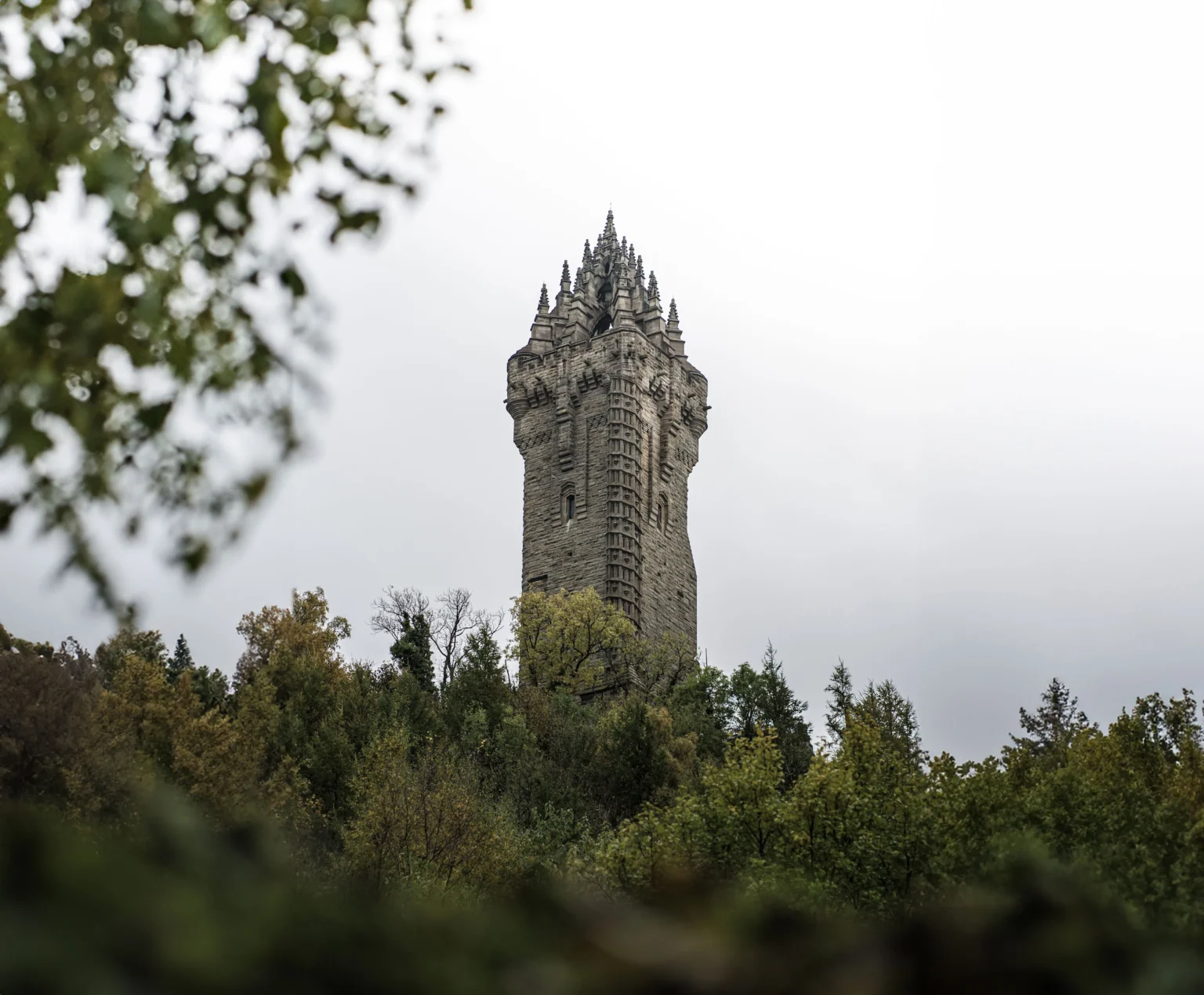 The Wallace Monument tower on Abbey Craig rising above the trees near Stirling