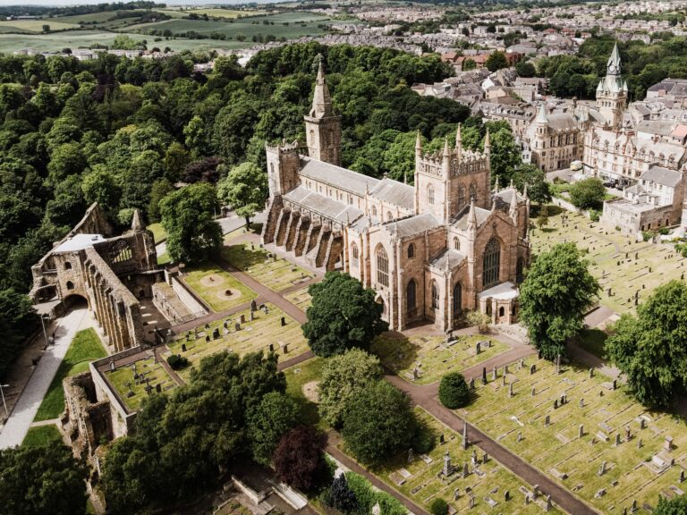 Aerial view of a historic abbey church and town in Fife, on the St Andrews day tour from Edinburgh