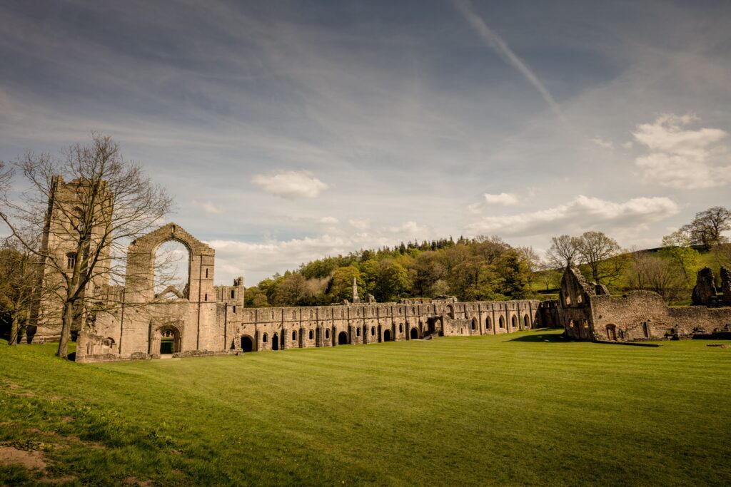 The roofless nave and arcading of a ruined medieval abbey
