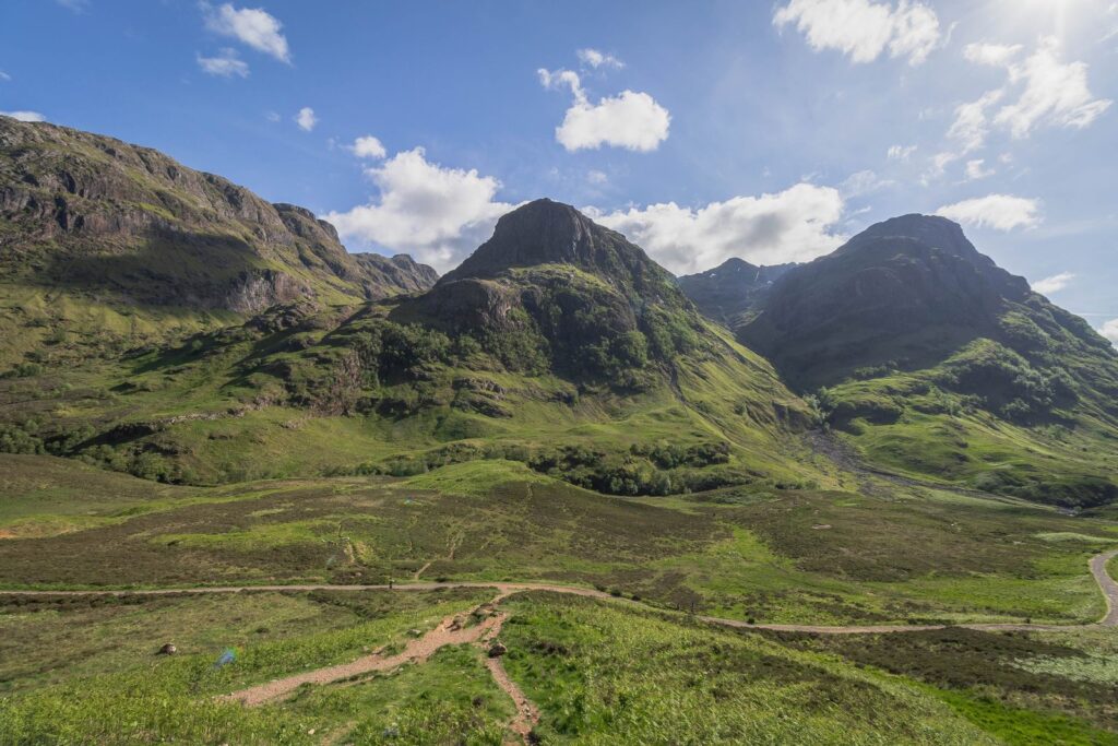 A path across the glen floor beneath the Three Sisters of Glencoe, where the Lost Valley hides between two of the peaks