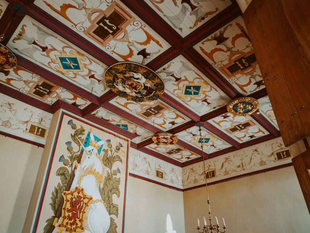 The painted ceiling of the Royal Palace at Stirling Castle, set with carved oak Stirling Heads and royal heraldry
