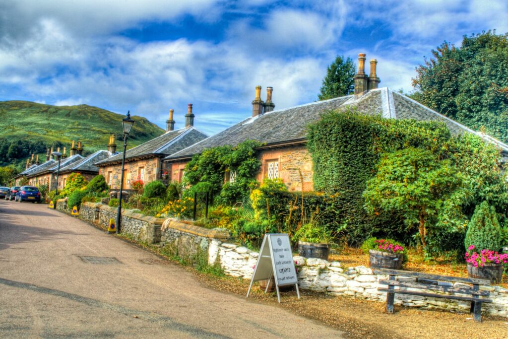 Stone cottages with flower-filled gardens on a lane in Luss village on Loch Lomond
