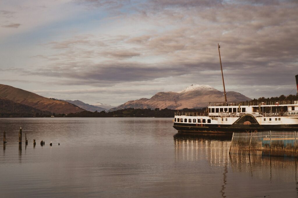 The Maid of the Loch paddle steamer at Balloch pier with Ben Lomond across Loch Lomond