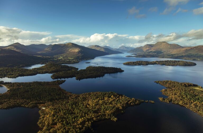 Aerial view of Loch Lomond and its wooded islands with the hills of the Trossachs beyond